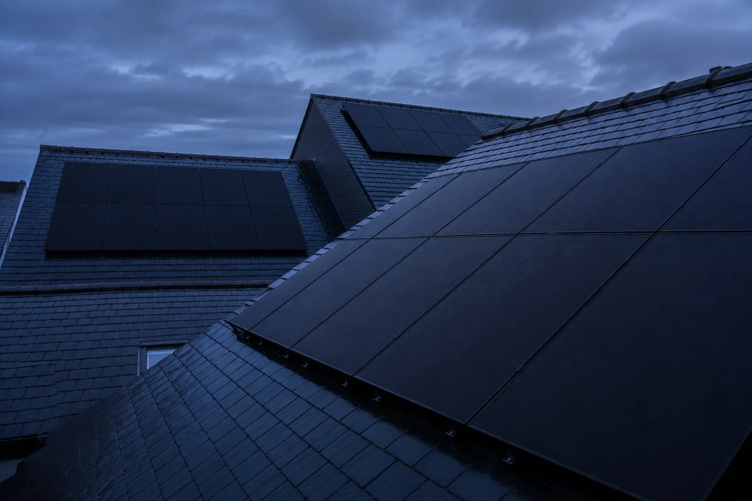 Power your UK home with JA Solar An all-black JA Solar array on a British roof at blue hour