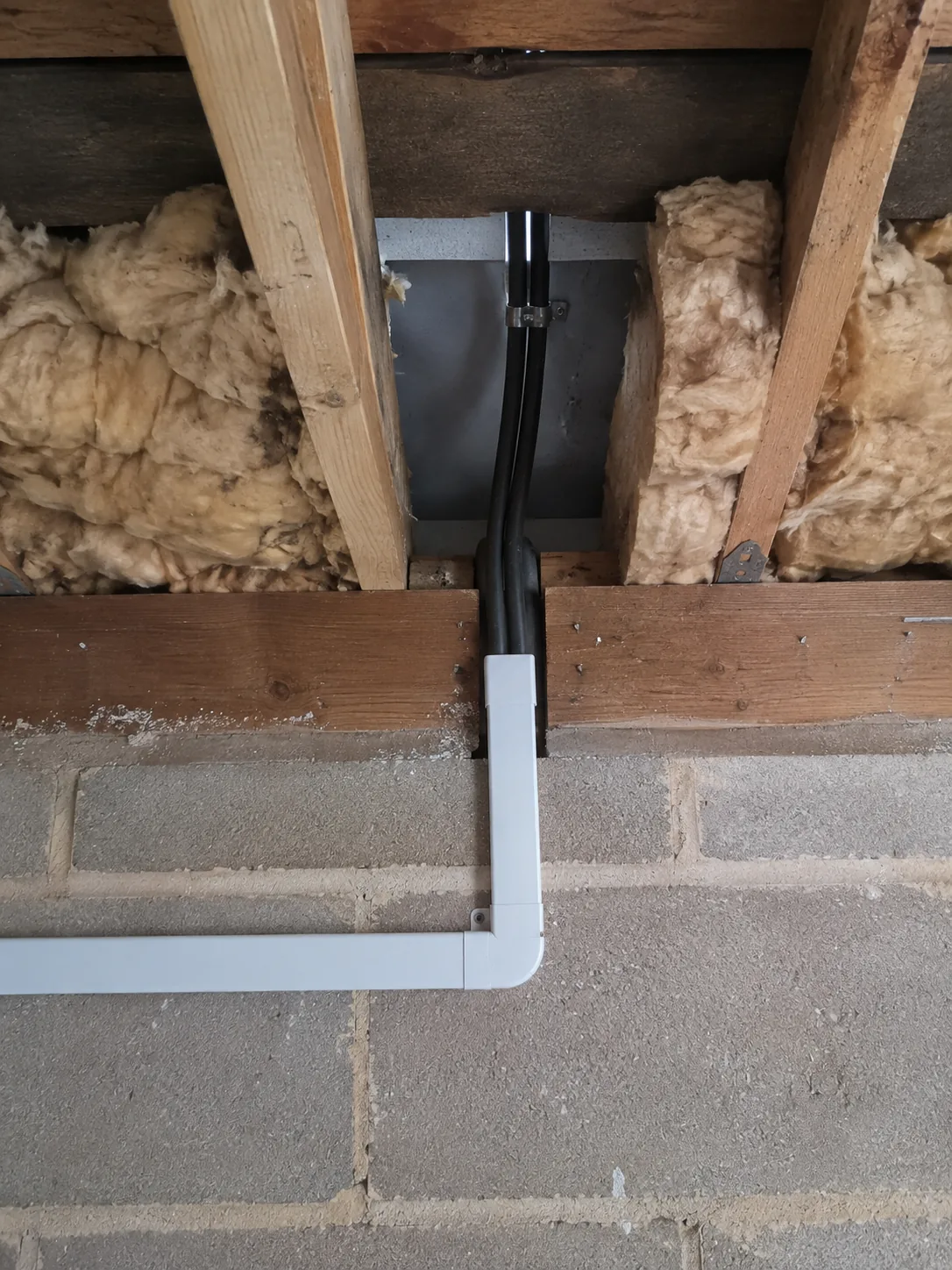 The last spare watt goes to hot water A cupboard in a British home with the cable run to a hot water cylinder